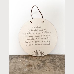Holzschild „Liebe bedeutet nicht, …“