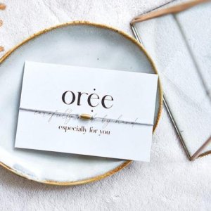 Graues Armband mit ovaler Makrameeperle