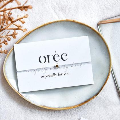 Graues Armband mit kleiner goldener Perle